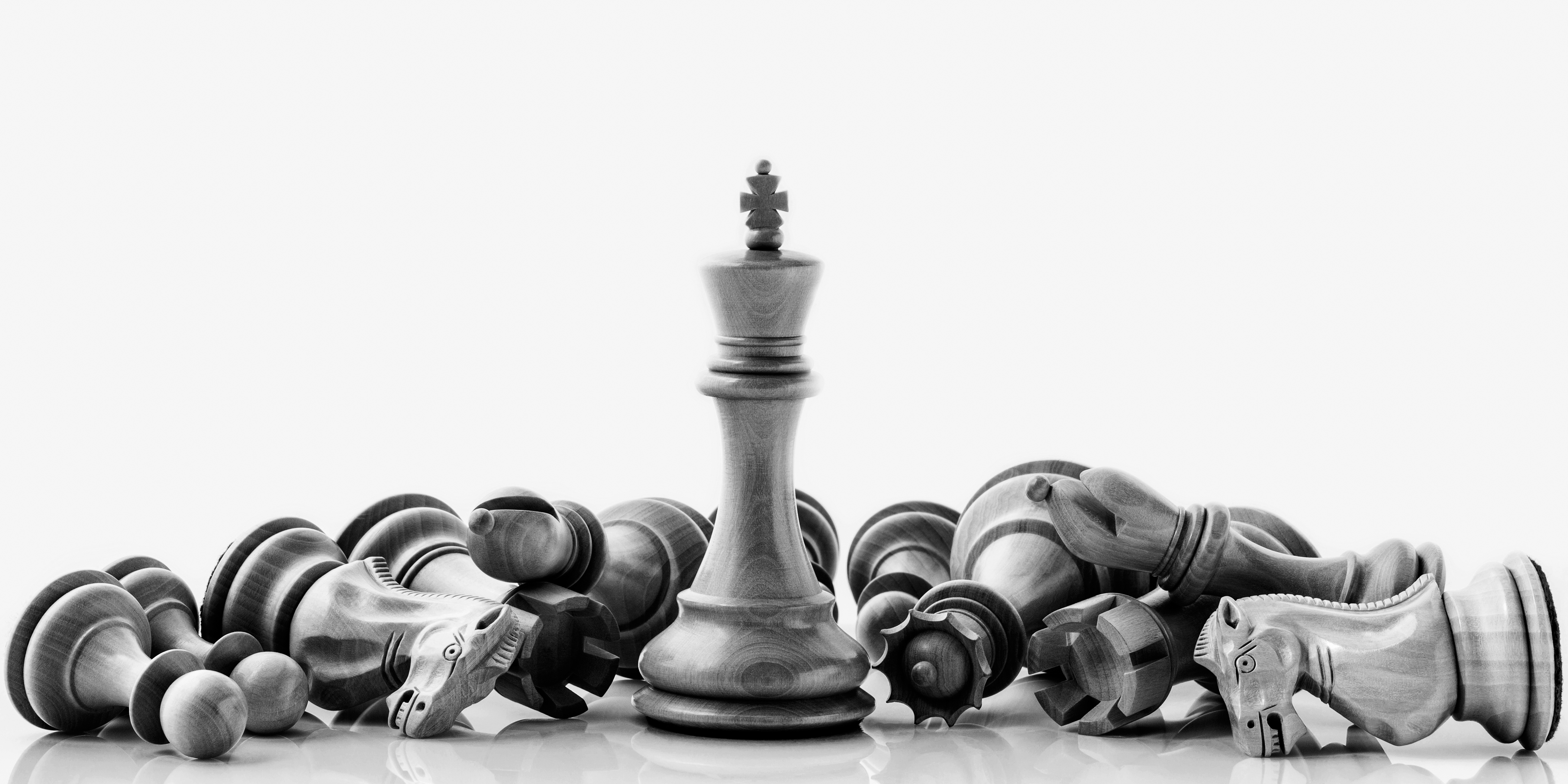 Strategic chess pieces on a reflective board